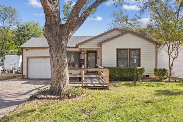 view of front of home with a garage and a front lawn