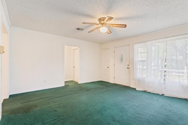 empty room with carpet, a textured ceiling, ceiling fan, and crown molding