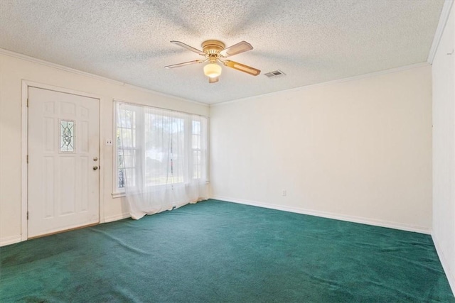 carpeted foyer entrance featuring a textured ceiling, ceiling fan, and crown molding