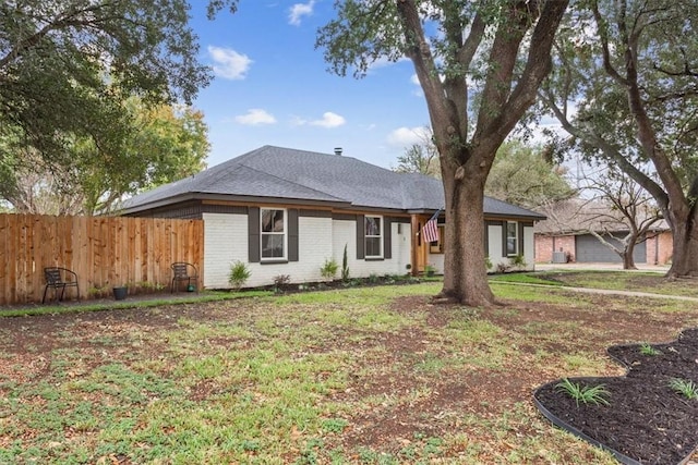 ranch-style home featuring a front yard