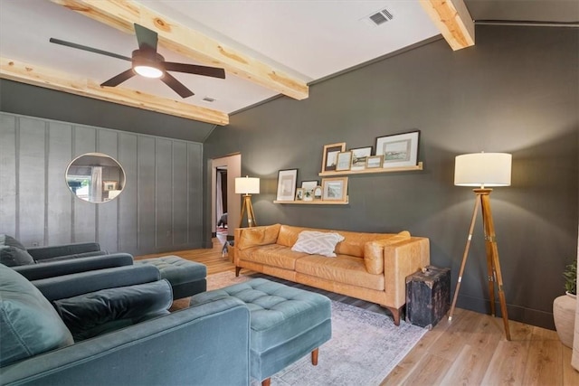 living room featuring ceiling fan, lofted ceiling with beams, and light wood-type flooring