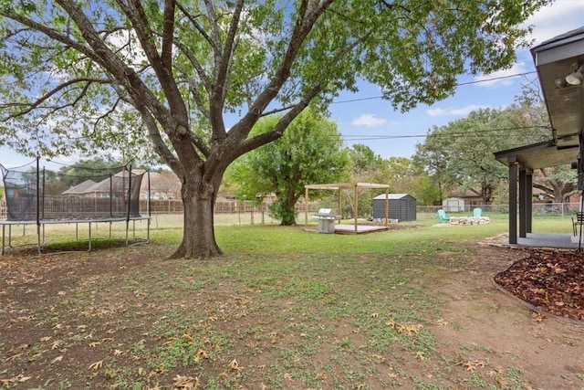 view of yard with a shed and a trampoline