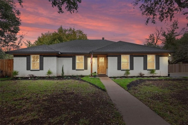 view of front of property with a lawn