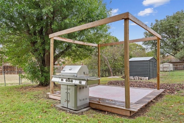 view of patio featuring a storage unit, area for grilling, and a wooden deck