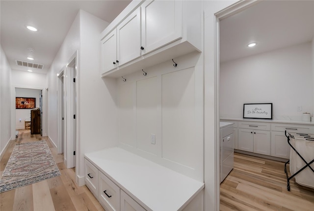 mudroom with light wood-type flooring and washer / clothes dryer