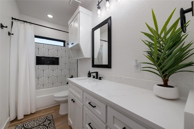 full bathroom featuring shower / bath combo with shower curtain, vanity, wood-type flooring, and toilet