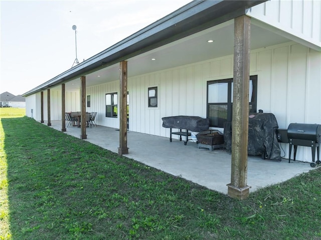 back of property with a patio area and a yard