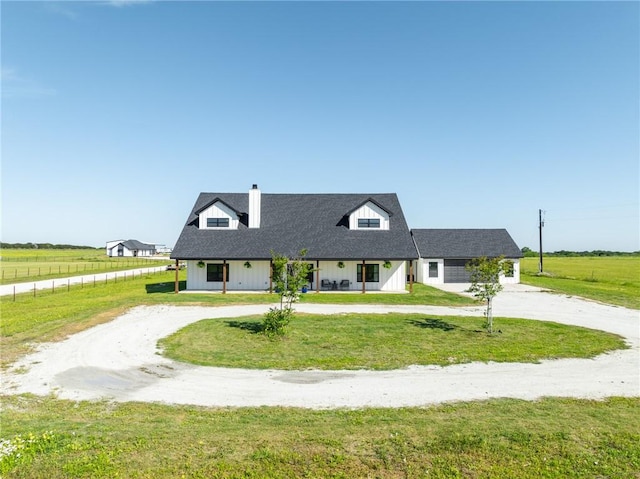 cape cod home featuring a front lawn