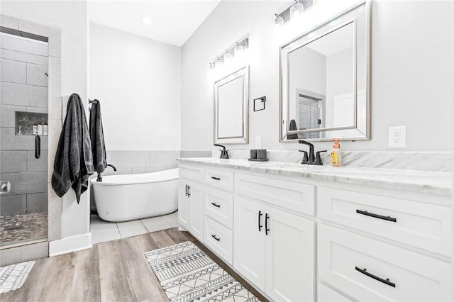 bathroom featuring separate shower and tub, wood-type flooring, and vanity