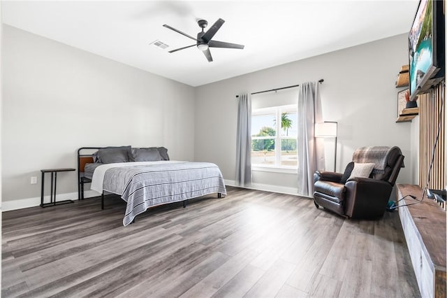 bedroom with ceiling fan and hardwood / wood-style flooring