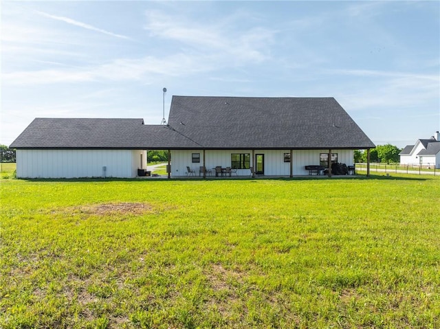 rear view of property featuring a yard