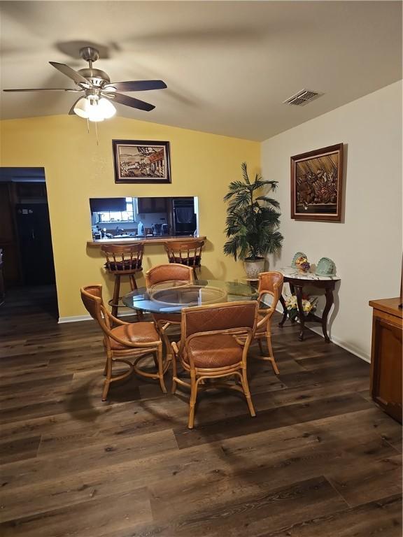 dining space with dark hardwood / wood-style flooring and ceiling fan