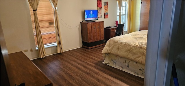 bedroom with dark wood-type flooring