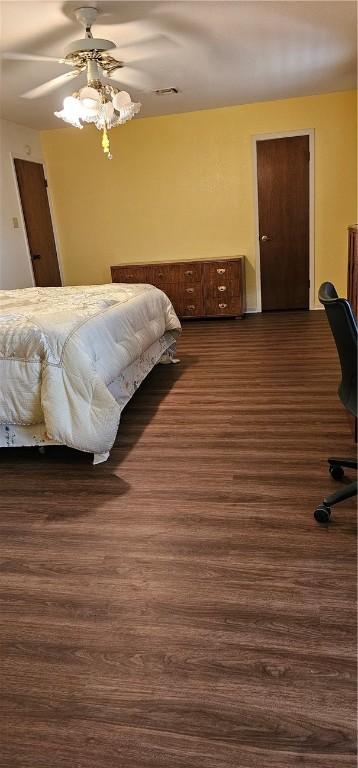 bedroom featuring ceiling fan and dark hardwood / wood-style flooring