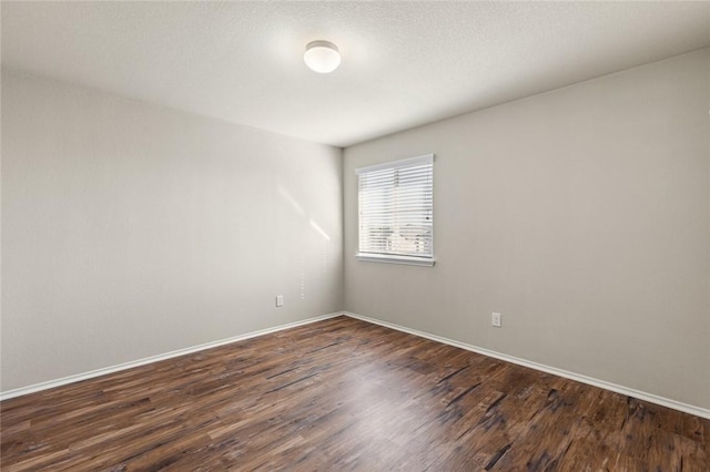 unfurnished room featuring dark hardwood / wood-style floors