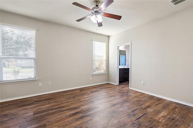 unfurnished room with dark hardwood / wood-style flooring, a wealth of natural light, and ceiling fan