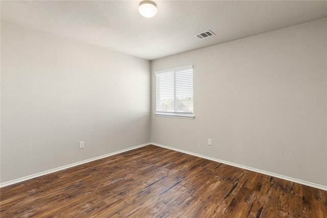 unfurnished room featuring dark hardwood / wood-style flooring