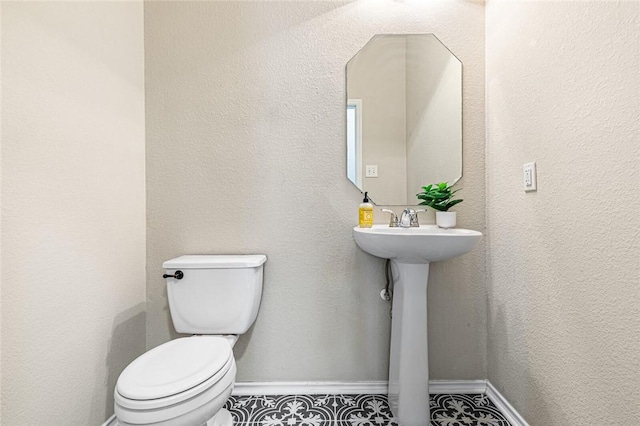 bathroom with tile patterned floors and toilet