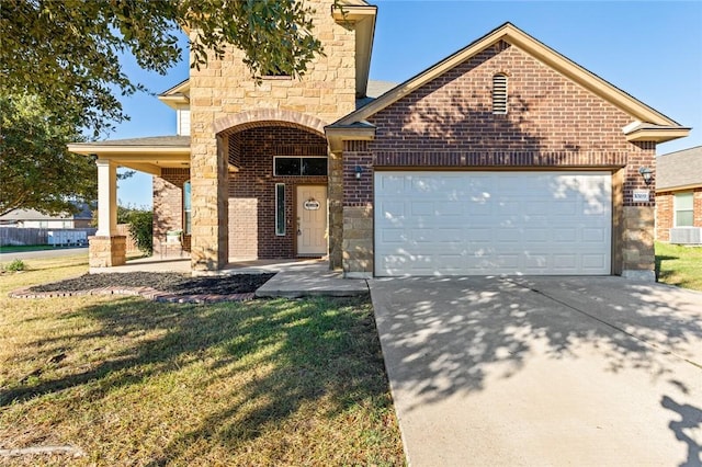 view of property featuring a front yard and a garage