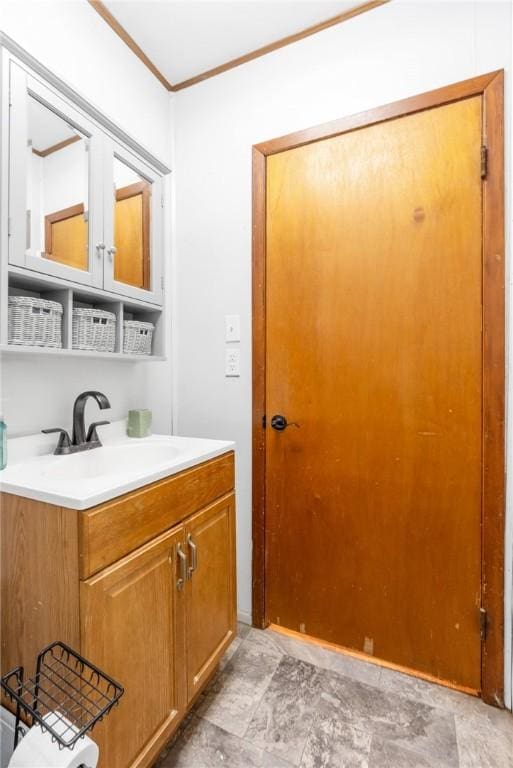 bathroom featuring ornamental molding and vanity