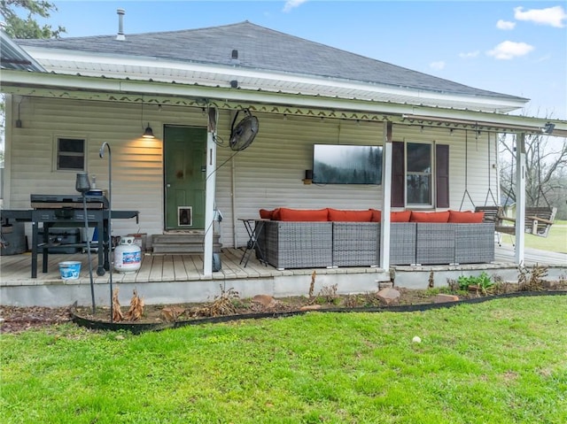 back of property with a yard and an outdoor hangout area