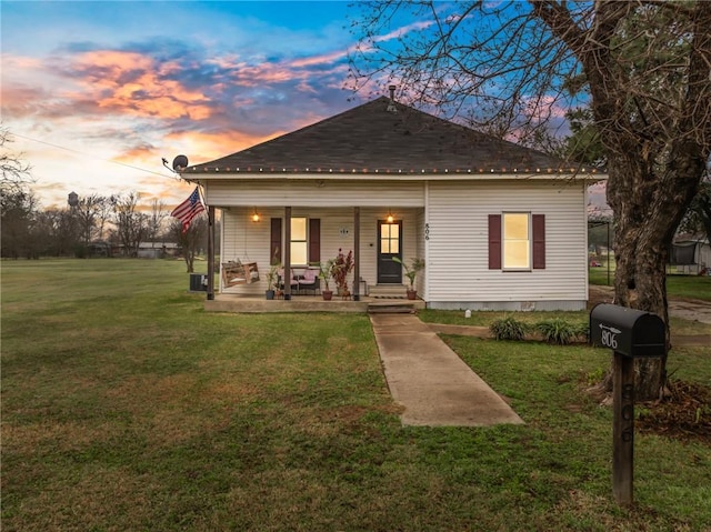 bungalow with a yard and covered porch