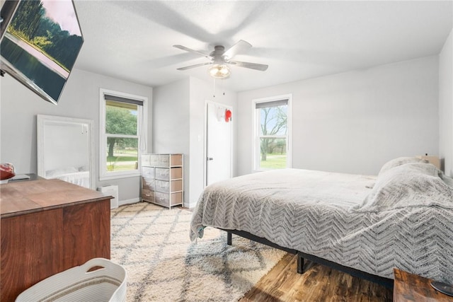 bedroom with light colored carpet and ceiling fan