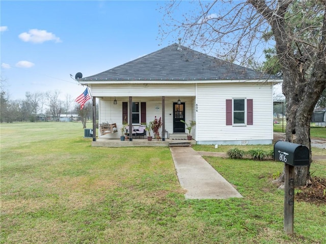 bungalow-style house with covered porch, central AC unit, and a front yard