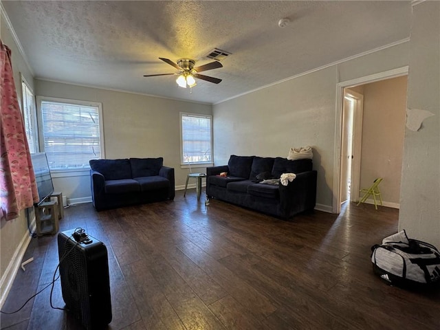 living room with a textured ceiling, ceiling fan, crown molding, and dark hardwood / wood-style floors