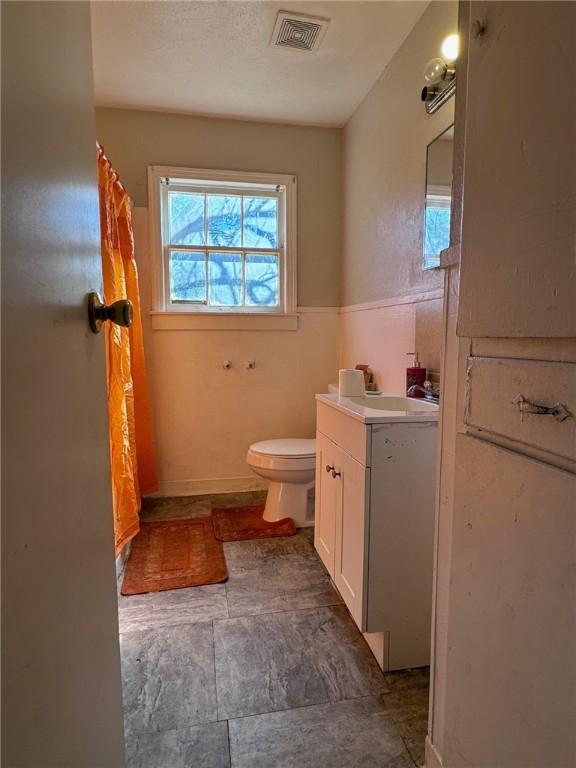 bathroom featuring vanity and toilet