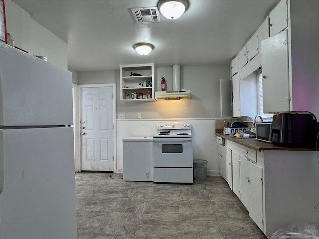 kitchen featuring extractor fan, white appliances, and white cabinetry