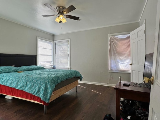 bedroom featuring ceiling fan, dark hardwood / wood-style flooring, and ornamental molding