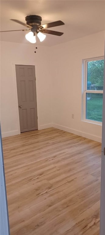 spare room with ceiling fan and light hardwood / wood-style floors