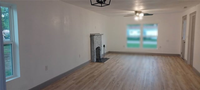 unfurnished living room with ceiling fan and light hardwood / wood-style flooring