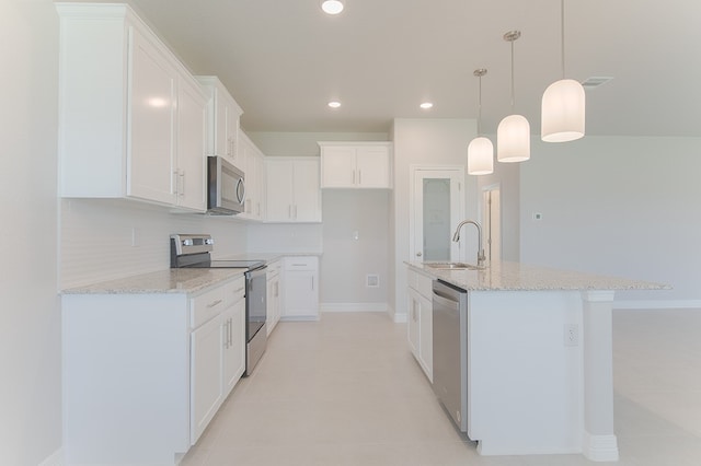 kitchen featuring white cabinets, sink, a kitchen island with sink, and appliances with stainless steel finishes