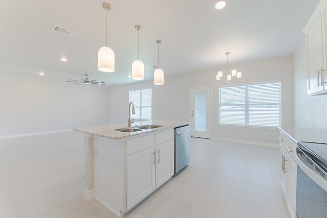 kitchen with white cabinets, appliances with stainless steel finishes, and a wealth of natural light