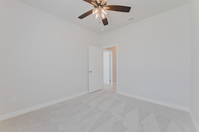 carpeted spare room with ceiling fan