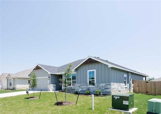 single story home featuring a garage and a front yard