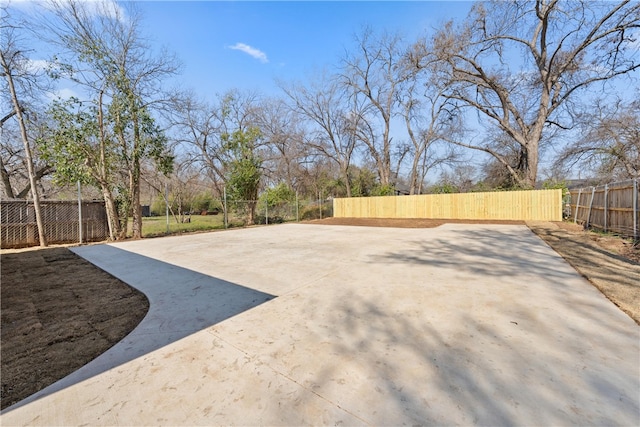 view of yard featuring driveway and fence