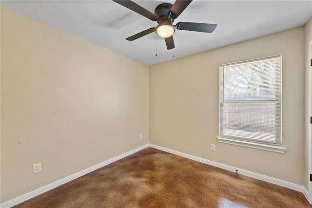 spare room featuring dark carpet, ceiling fan, and baseboards