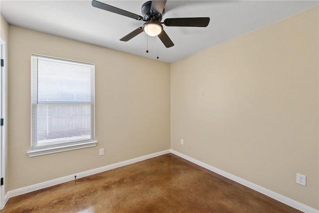 unfurnished room with a ceiling fan and baseboards