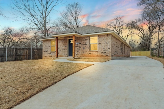 view of front facade featuring fence and brick siding