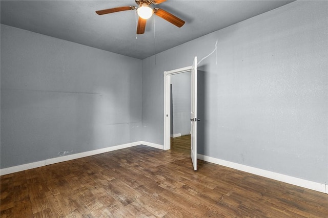 spare room featuring dark hardwood / wood-style floors and ceiling fan