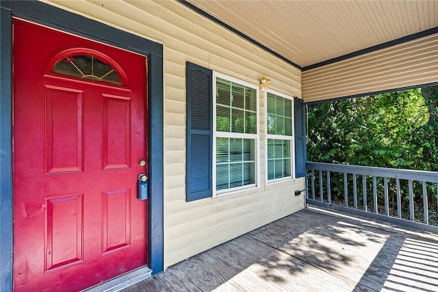 view of exterior entry featuring a porch