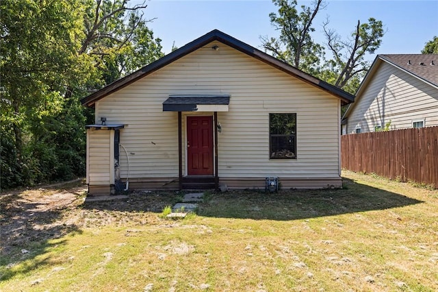 bungalow-style home with a front lawn