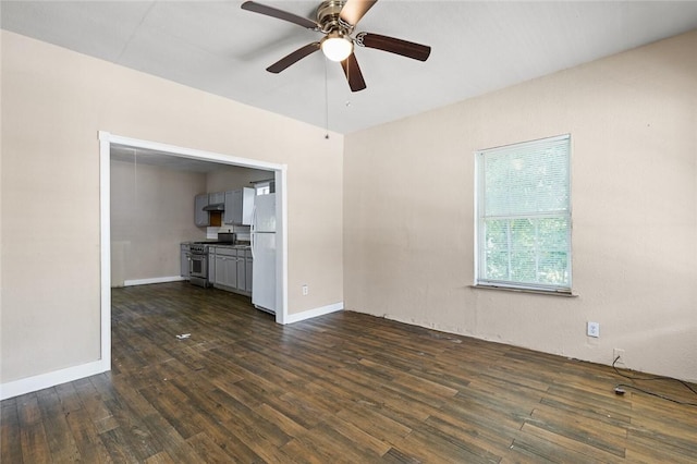 unfurnished living room with ceiling fan and dark wood-type flooring