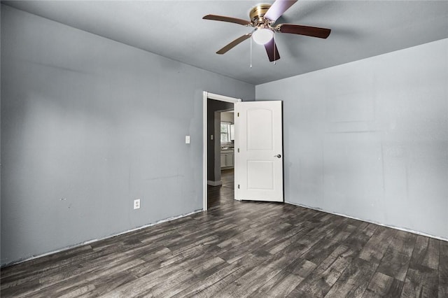 unfurnished room featuring ceiling fan and dark wood-type flooring