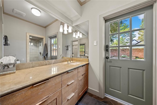 bathroom with vanity, a shower, and ornamental molding