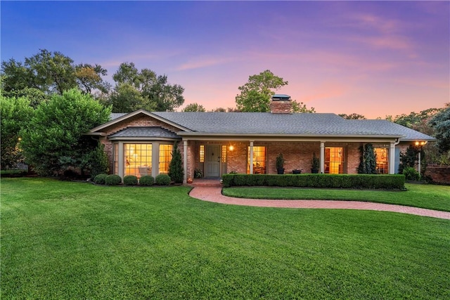 ranch-style house featuring a yard