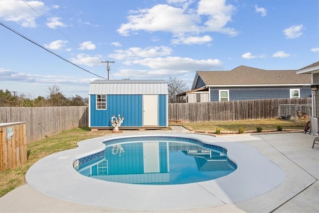 view of pool with a shed and a patio